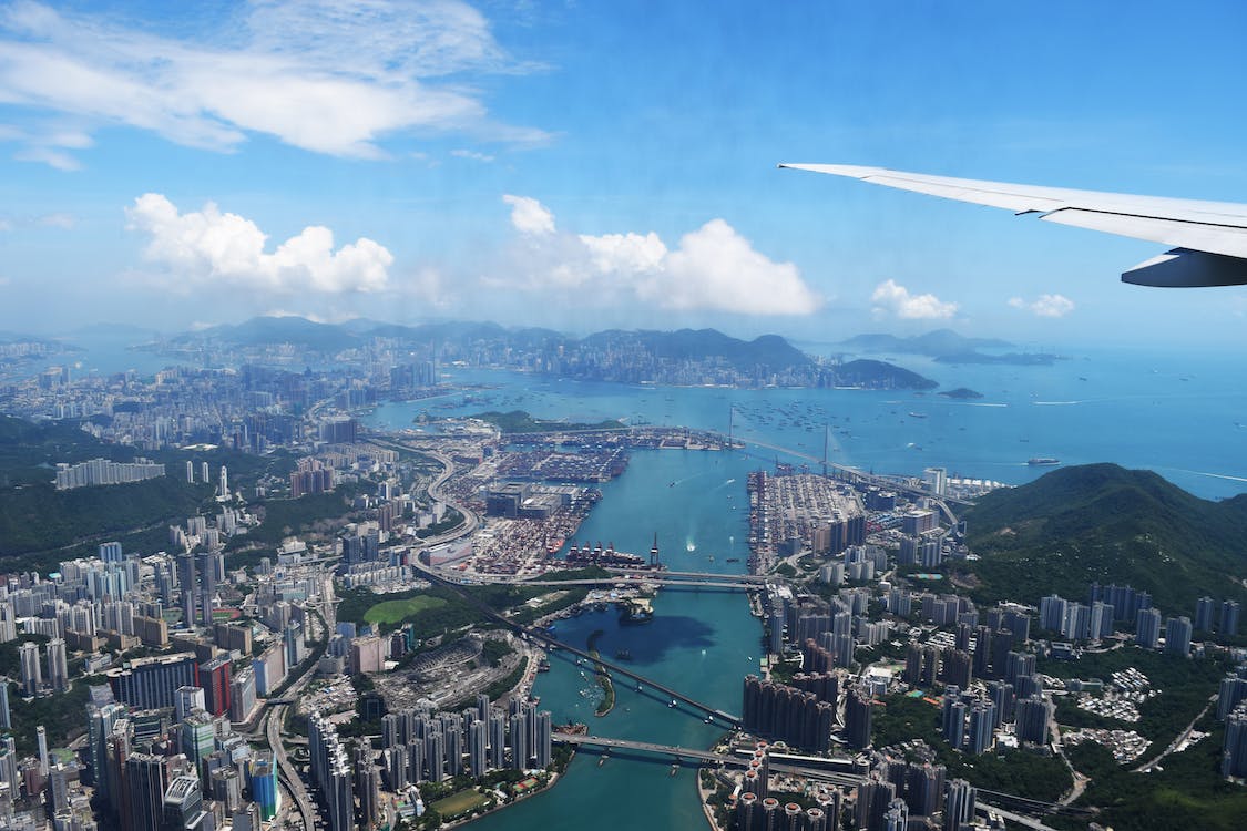 Free Aerial View of City Through Airplane Window Stock Photo