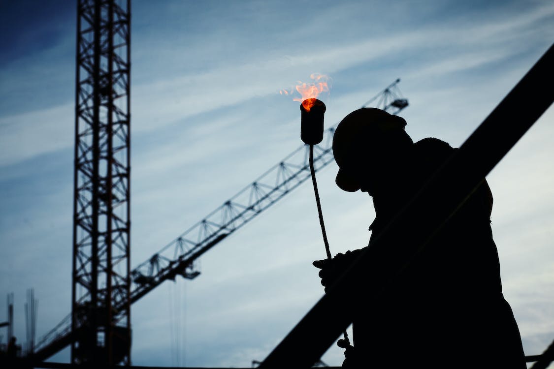 Free Silhouette of Man Holding Flamethrower Stock Photo